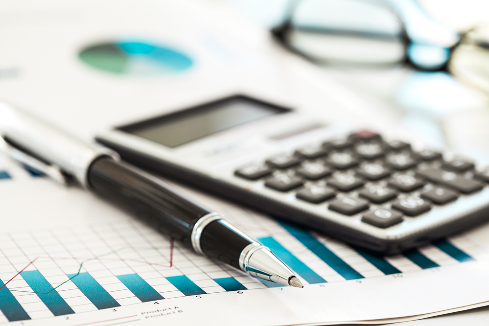 Pen, calculator and financial graphics